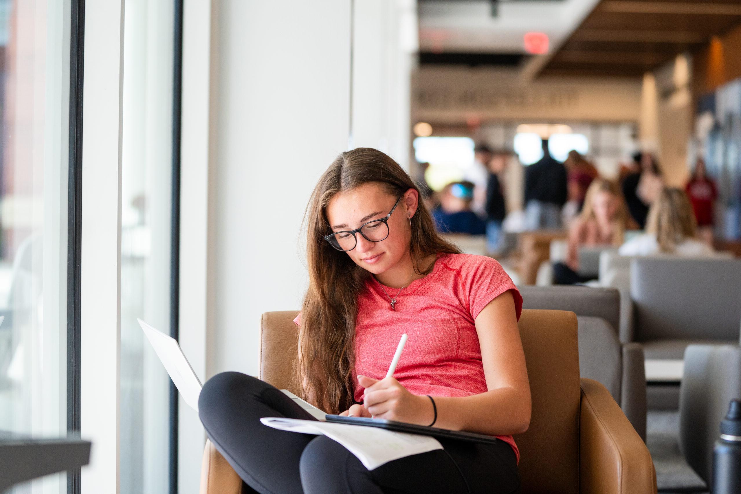 Student studying by a window